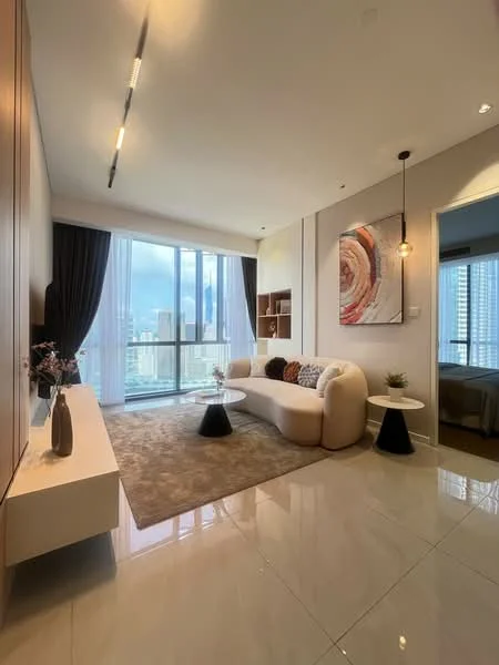 Living features: curved white sofa, round coffee table, area rug with neutral tones, wall-mounted TV, built-in shelving unit, floor-to-ceiling windows, black accent tables, decorative wall art, curtains, marble tile flooring, recessed ceiling lights; style: modern; view: city.