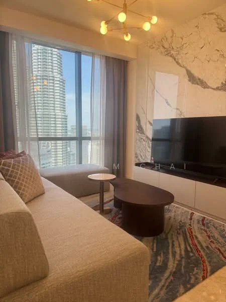 Living features: floor-to-ceiling windows, grey fabric sofa, round coffee table, TV console, wall-mounted TV, marble accent wall, area rug with abstract pattern, chandelier with multiple bulbs; style: modern; view: city.