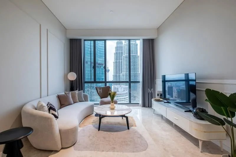 Living features: curved beige fabric sofa, round coffee table with black base, white TV console, wall-mounted flat-screen TV, marble flooring, large floor-to-ceiling windows, city skyline view, decorative houseplant, area rug with light pattern, wall sconce lighting, grey curtains; style: modern; view: city.