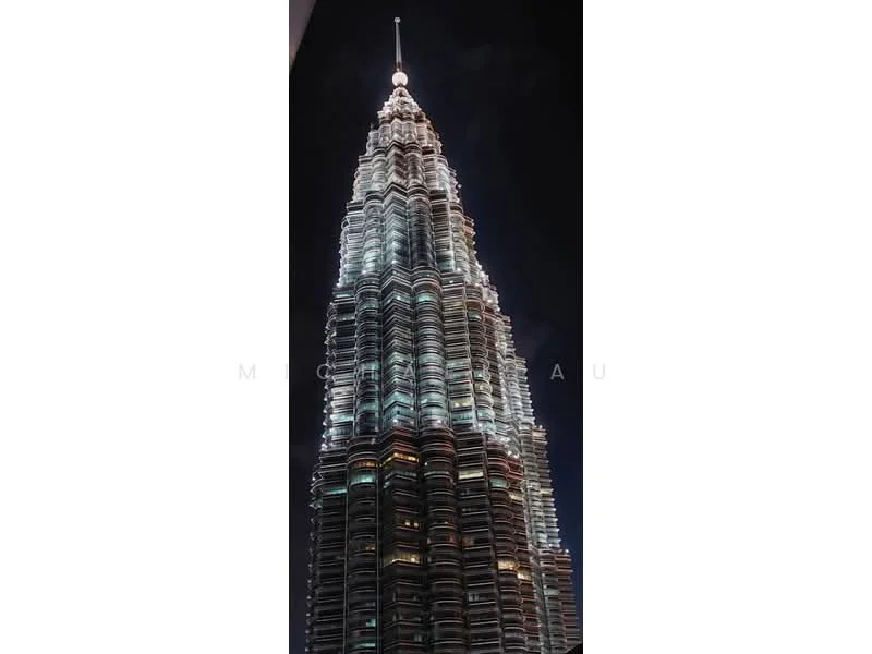 Exterior type: high-rise condominium; features: glass curtain wall, illuminated facade, recessed balconies, vertical fins, feature lighting at night; style: modern.