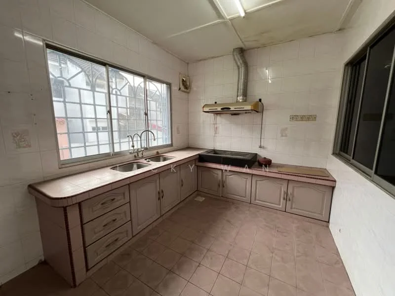 Kitchen features: double-bowl stainless-steel sink, chrome pull-down faucet, black countertop, cream cabinetry with handles, tile backsplash, wall-mounted range hood, window with grid pattern, light brown tile flooring, exhaust pipe, built-in cabinets, open shelving.