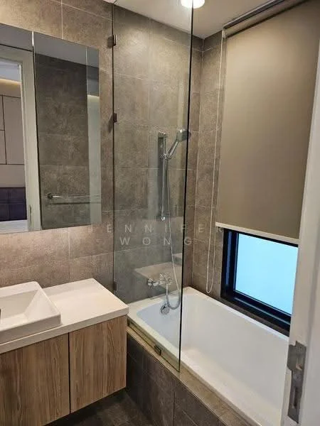 Bathroom features: glass shower enclosure, rain shower head, handheld shower, built-in bathtub, single-sink vanity with wood cabinet, white countertop, wall-mounted faucet, mirror above vanity, tile cladding on walls, grey ceramic tile flooring, roller blinds on window; style: modern.