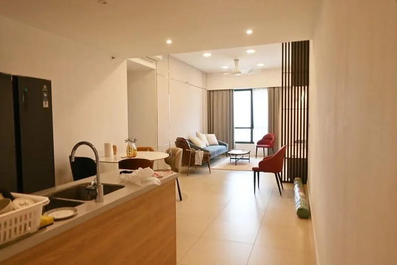 Kitchen features: stainless-steel fridge, single-bowl stainless-steel sink, chrome pull-down faucet, wood cabinetry, countertop with breakfast bar, open shelving; style: modern. Living features: 3-seater fabric sofa in light blue, 2-seater red armchair, coffee table, area rug, ceiling fan, floor-to-ceiling windows, curtains, wall-mounted TV; style: modern.
