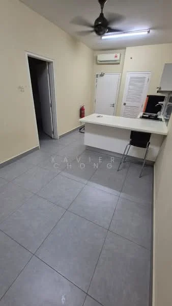 Room features: grey tile flooring, white painted walls, ceiling fan, wall-mounted air conditioning unit, countertop with bar seating, fire extinguisher, doorway leading to another room, door with louvered panels; style: modern.