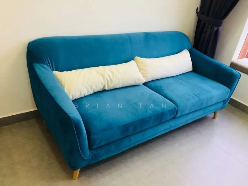 Living features: teal fabric sofa, two white throw pillows, grey tile flooring, white painted walls, dark curtain, window sill, natural light from window; style: modern.