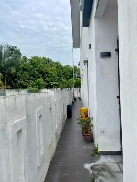 Exterior features: white painted facade, grey tiled flooring, potted plants, fenced walkway, outdoor wall lighting, manicured greenery; style: modern.