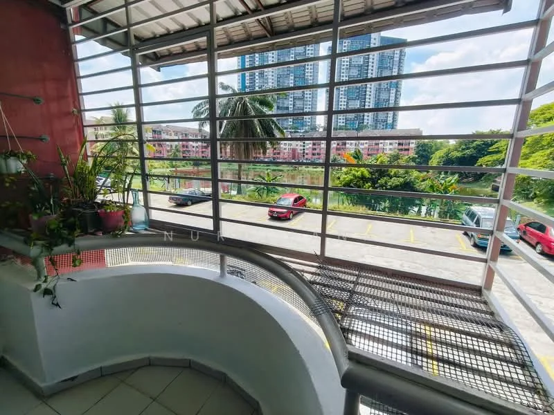 Room features: metal railing, sliding window with horizontal bars, tiled flooring, potted plants, curved balcony design, view of water body, view of surrounding buildings, outdoor parking area visible; style: modern; view: water.