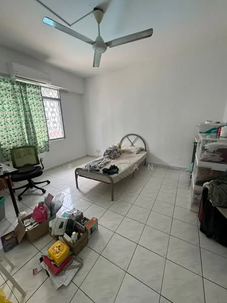 Bedroom features: single bed frame, mattress, ceiling fan, green patterned curtains, white painted walls, tile flooring, window with security grill, cluttered with boxes and items.