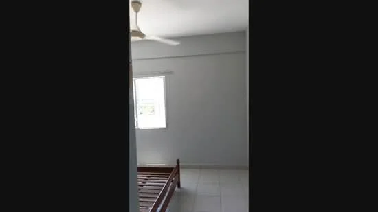 Bedroom features: white painted walls, ceiling fan, window with view, tiled flooring, wooden bed frame, natural light from window.