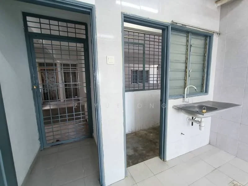 Room features: grey tiled flooring, white painted walls, metal grilles on doors and windows, single-bowl stainless-steel sink, wall-mounted faucet, window with metal grilles, open layout, natural light from windows.
