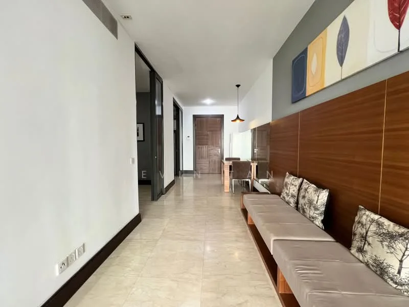 Room features: cream marble flooring, white painted walls, wood panel accent wall, recessed downlights, pendant light, sofa with decorative cushions, mirror on wall, wooden console table; style: modern.