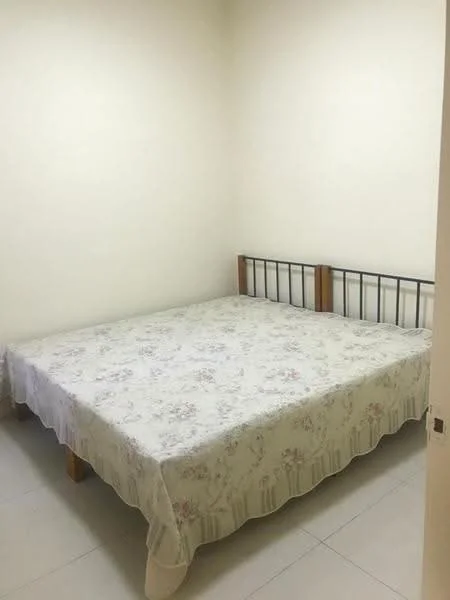 Bedroom features: queen-size bed, floral-patterned bedspread, plain white walls, tile flooring, wooden bed frame, single window, minimal decor; style: minimalist.