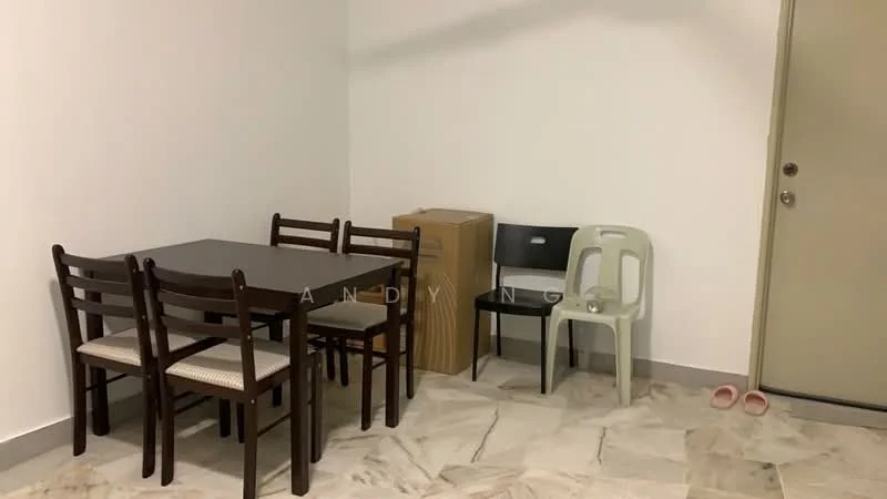 Dining features: 4-seater dining table with dark wood finish, wooden dining chairs with upholstered seats, light-coloured marble flooring, white painted walls, cardboard boxes stacked in corner, plastic chair in light green, slippers on the floor, door visible in background.