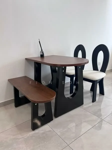 Dining features: wooden dining table with rounded edges, black base with cut-out design, two black dining chairs with curved backs, white upholstered seat cushions on chairs, wooden bench with black base, glossy tile flooring, neutral wall color, minimalist decor; style: modern.