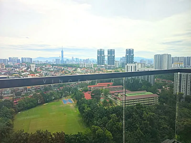Exterior type: high-rise condominium; features: glass balcony railing, city skyline view, green landscape below, surrounding high-rise buildings, open sky, urban residential area; style: modern.