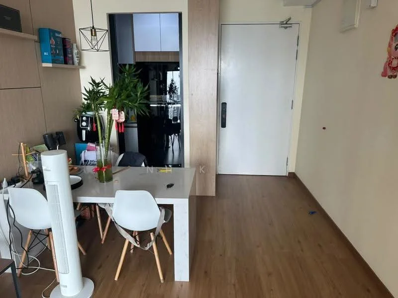Room features: wood laminate flooring, light beige painted walls, white dining table, two white dining chairs, green indoor plants, wall-mounted cabinet, black kitchen cabinetry visible in background, door leading to another room, air purifier, decorative wall art, light fixture hanging from ceiling; style: modern.