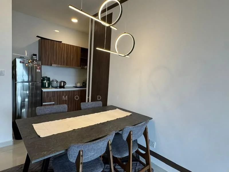 Dining features: 6-seater dining table with dark stone top, upholstered dining chairs in grey, pendant light fixture with circular design, white walls, tile flooring, kitchenette visible in background with wooden cabinetry, stainless-steel fridge, kettle on countertop, open shelving in kitchen area; style: modern.