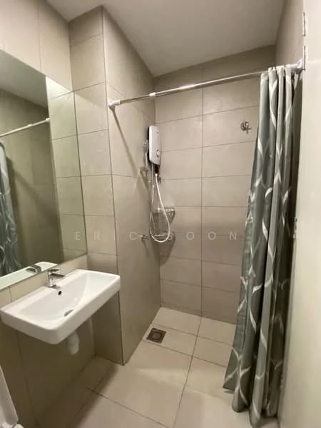 Bathroom features: light grey tiled walls, beige tiled flooring, walk-in shower with glass partition, wall-mounted shower head, handheld shower, chrome shower mixer, white wall-mounted sink, mirror above sink, shower curtain with geometric pattern, toilet, drain in floor; style: modern.