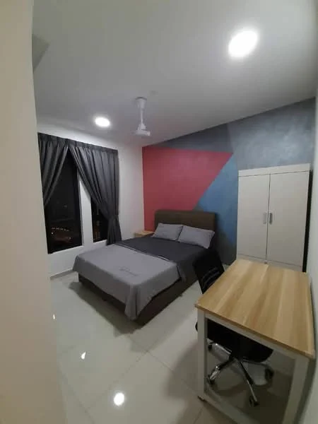 Bedroom features: king-size bed with grey bedding, upholstered headboard, floor-to-ceiling window, grey curtains, accent wall with geometric design in red and blue, white painted walls, polished tile flooring, ceiling fan, study desk with wooden top, black office chair, built-in wardrobe; style: modern; view: city.