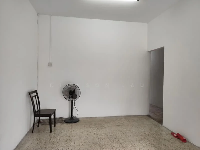 Room features: white painted walls, cement flooring, ceiling fan, single wooden chair, doorway leading to another room; style: minimalist.