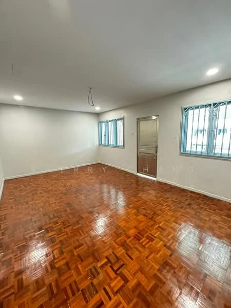 Room features: parquet wood flooring, white painted walls, recessed downlights, two windows with metal grilles, single door leading to another room, no visible furniture, smooth ceiling, bright natural light.