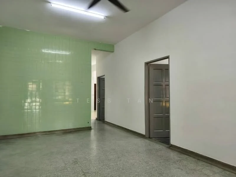 Room features: green tiled wall, white painted walls, polished concrete flooring, ceiling with fluorescent lighting, doorway leading to another room, doorway leading to hallway, ceiling fan; style: modern.