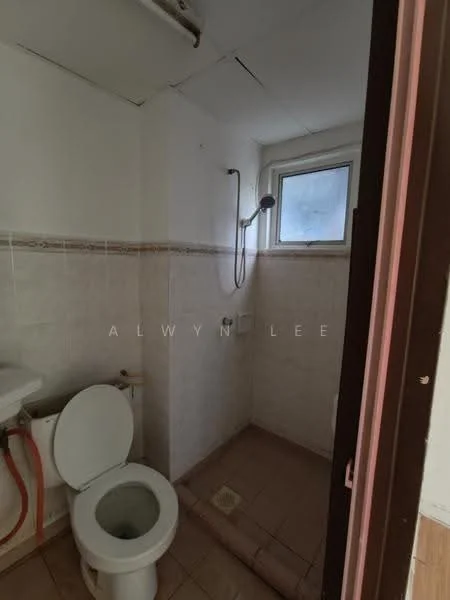 Bathroom features: white tiled walls, cream tiled flooring, one-piece toilet, shower with handheld shower head, window for natural light, exposed plumbing, tile cladding around shower area, small drainage floor.