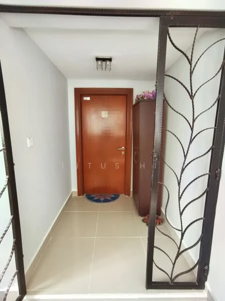 Room features: grey tiled flooring, white painted walls, wooden door with handle, decorative wall panel, ceiling light fixture, doormat, shoe cabinet, metal gate with leaf design; style: modern.