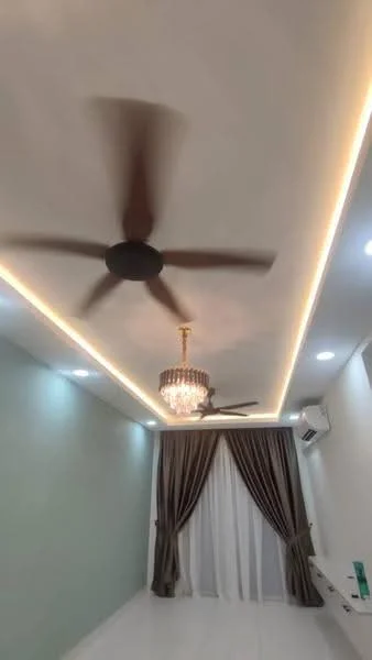 Room features: white walls, tray ceiling, recessed LED downlights, chandelier, 5-blade ceiling fan, curtains in dark brown and white, light-coloured flooring, wall-mounted air conditioning unit, decorative wall trim, LED strip lighting; style: modern.