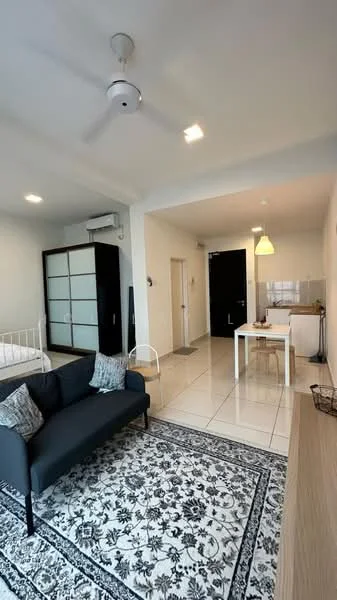 Living features: 3-seater fabric sofa in dark grey, area rug with intricate pattern, ceiling fan with light, white painted walls, tile flooring, recessed downlights, coffee table, decorative cushions; style: modern. Bedroom features: queen-size bed with white bedding, built-in wardrobe with sliding doors, white walls, tile flooring; style: modern. Dining features: small dining table for two, white chairs, kitchenette area visible, tile flooring; style: modern.
