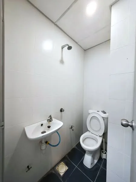 Bathroom features: white tiled walls, black tiled flooring, single-sink vanity with chrome faucet, one-piece toilet, shower head with wall-mounted fixture, ceiling light, mirror above sink; style: modern.