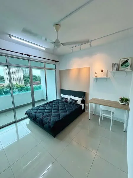 Bedroom features: king-size bed with black quilted bedding, upholstered headboard, 2 bedside pillows, white wall-mounted shelf, study desk with white chair, floor-to-ceiling windows, sliding glass door, white painted walls, glossy tile flooring, ceiling fan with light, decorative plant on desk, view of balcony; style: modern; view: city.