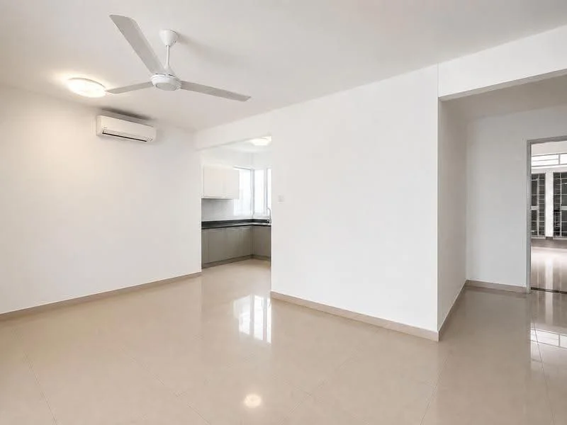 Living features: white painted walls, polished floor tiles, 5-blade ceiling fan with light, wall-mounted split AC, natural light from windows, open layout to kitchen, neutral color scheme, no visible furniture; style: modern. Kitchen features: white cabinetry, black countertop, stainless-steel sink, built-in appliances, natural light from windows; style: modern.