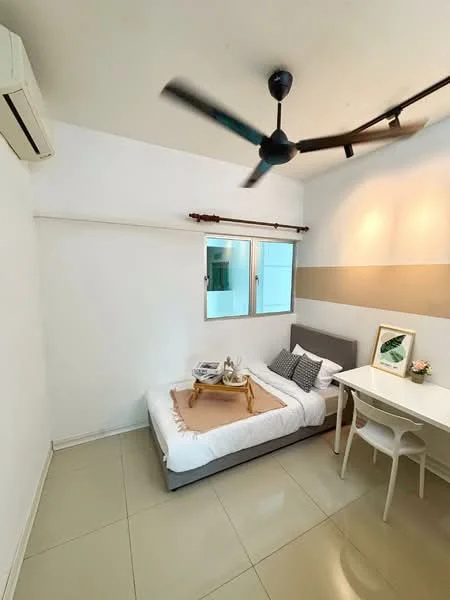 Bedroom features: single bed with white bedding, grey upholstered headboard, white walls, cream accent wall, floor-to-ceiling windows, 2-pane casement windows, white ceiling, 5-blade ceiling fan, light-colored tile flooring, study desk with white finish, decorative tray on bed, houseplant on desk; style: modern.