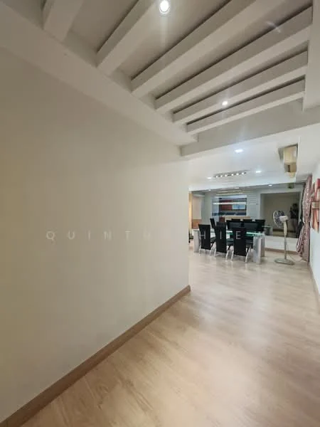 Room features: wooden flooring, white painted walls, exposed beams on ceiling, recessed lighting, open layout, dining area visible in background, neutral color palette; style: modern.