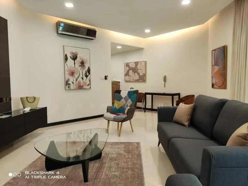 Living features: grey fabric sofa, glass coffee table, wooden side table, decorative wall art with floral pattern, recessed LED downlights, wall-mounted split AC, cream painted walls, marble flooring, area rug, accent chair with patterned upholstery; style: modern.