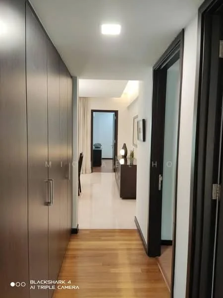 Hallway features: wooden flooring, white painted walls, recessed ceiling lights, built-in cabinets with dark wood finish, doorway leading to another room, doorway leading to a room on the right, neutral color curtains, decorative table in the distance; style: modern.