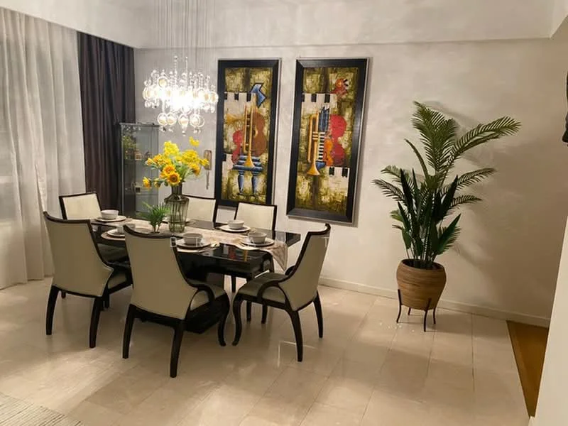 Dining features: 6-seater dining table with glass top, upholstered dining chairs in cream, chandelier with multiple bulbs, decorative wall art with abstract patterns, potted plant in decorative pot, floor-to-ceiling curtains in light fabric, cream painted walls, marble tile flooring; style: modern.