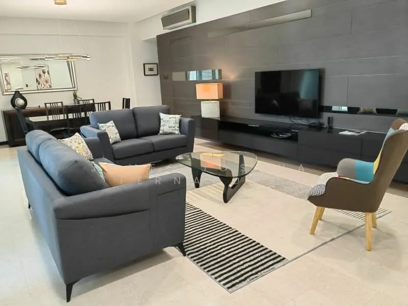 Living features: 3-seater fabric sofa in grey, 2-seater fabric sofa in grey, glass coffee table, TV console with wall-mounted TV, decorative wall panel in dark grey, area rug with striped pattern, pendant light fixture, dining table with black chairs in background, air conditioning unit on wall; style: modern.