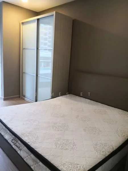 Bedroom features: queen-size bed, upholstered headboard, built-in wardrobe with sliding doors, light grey painted walls, laminate flooring, window with natural light, decorative bedding; style: modern.