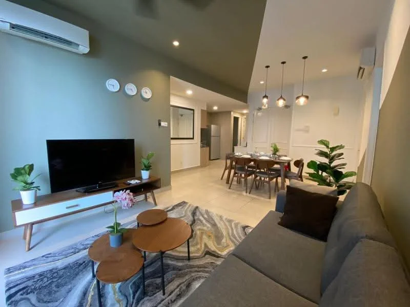 Living features: 3-seater fabric sofa in grey, 2 round coffee tables, area rug with abstract pattern, wall-mounted TV, TV console with storage, potted plants, 5-blade ceiling fan, wall clock, painted accent wall in green, recessed downlights; style: modern. Dining features: 6-seater dining table, upholstered dining chairs, pendant lighting above dining table, open layout to kitchen, decorative wall paneling; style: modern. Kitchen features: kitchen island, built-in oven, refrigerator, white cabinetry, countertop with backsplash, open shelving, stainless-steel sink, chrome pull-down faucet; style: modern.