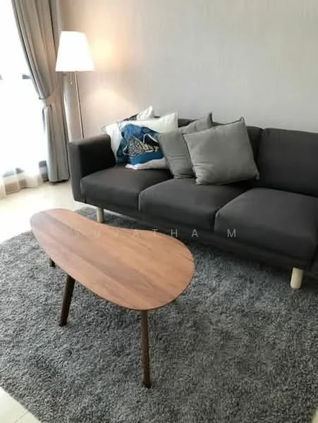 Living features: grey fabric sofa, wooden coffee table with curved shape, area rug in grey, floor lamp, decorative cushions, curtains, light-colored walls, natural light from window; style: modern.