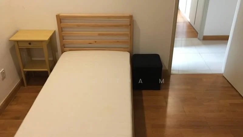 Bedroom features: single bed frame, mattress without bedding, wooden nightstand, dark storage ottoman, laminate flooring, white painted walls, doorway leading to hallway; style: minimalist.