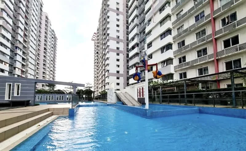 Exterior type: high-rise condominium; features: swimming pool, water slide, pool deck with loungers, children's playground, landscaped garden, multiple storeys, balconies on units, glass railing, modern architecture; style: modern.