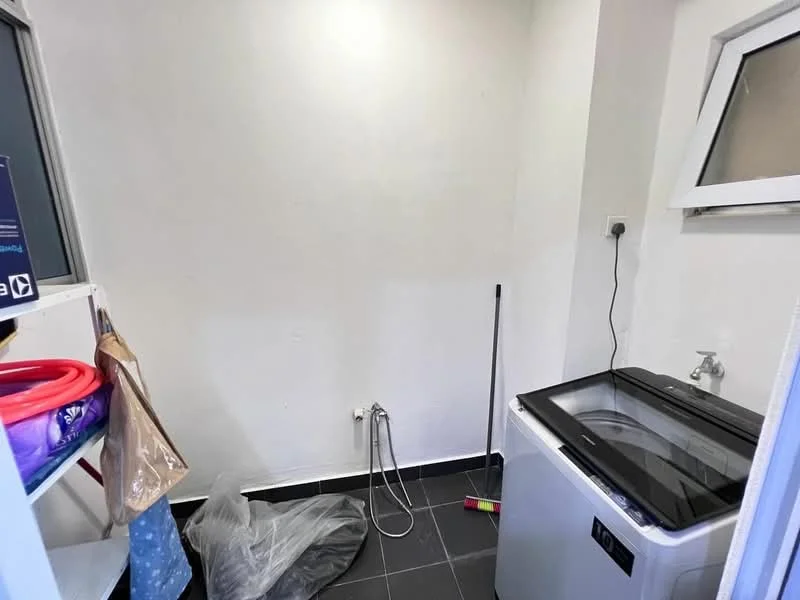 Laundry features: front-load washing machine, black countertop, white walls, black tile flooring, utility sink, exposed plumbing, window for natural light, storage shelves, cleaning supplies, mop, broom.