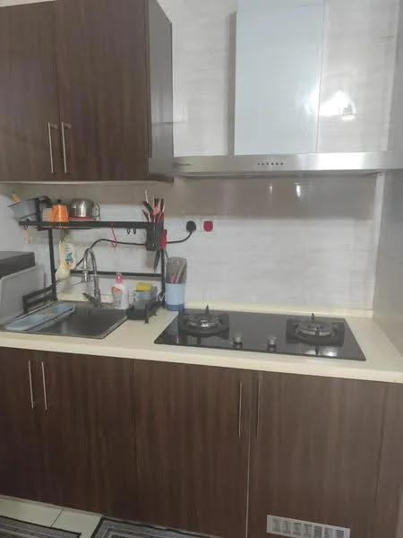 Kitchen features: brown wooden cabinetry, white countertop, stainless-steel sink, chrome pull-down faucet, built-in gas hob with two burners, stainless-steel range hood, kitchen utensils on wall rack, wall-mounted shelf, tile backsplash, grey rug on floor; style: modern.