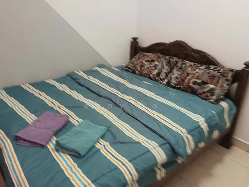 Bedroom features: king-size bed, wooden bed frame, decorative pillows, striped bedding in blue and yellow, two towels in different colors, white painted walls, tile flooring.