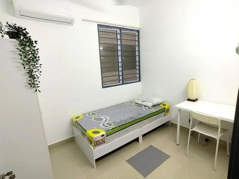 Bedroom features: single bed with mattress, white bed frame, green bedspread, desk with chair, table lamp, floor tiles, air conditioning unit, window with black metal grille, white painted walls, green plant decor; style: minimalist.