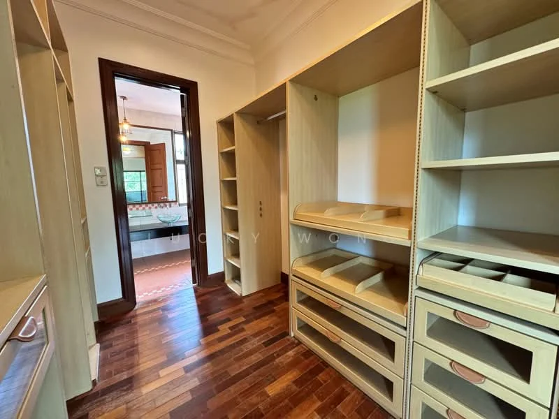 Room features: built-in wooden shelving, open shelving units, drawers with handles, wooden flooring, doorway leading to another room, natural light from adjacent room, neutral wall color, crown moulding; style: modern.