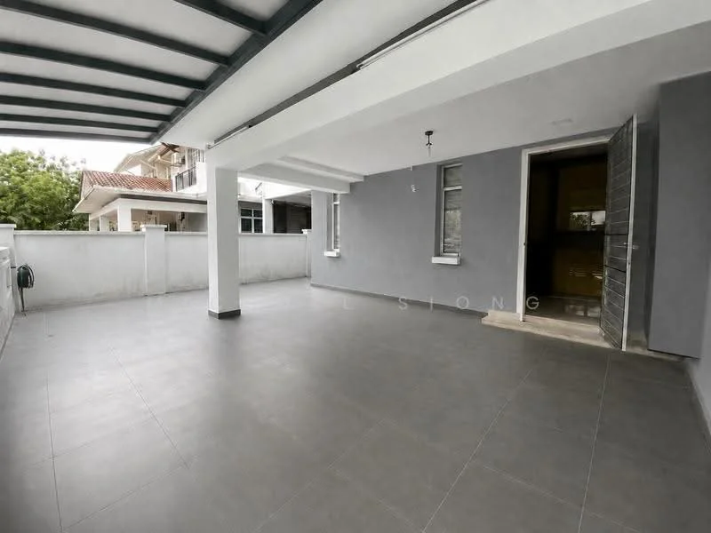 Exterior features: grey painted walls, grey tiled flooring, covered patio area, open space, sliding glass door, single door entrance, exposed beams, surrounded by low wall, natural light from windows, manicured greenery visible in background; style: modern.